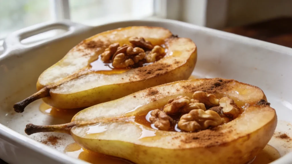 Two baked pears with honey walnut filling on a rustic wooden board, sprinkled with cinnamon