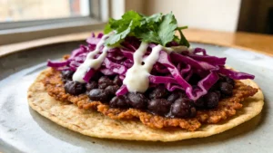 Crispy vegan smash tacos topped with pickled cabbage on a wooden board