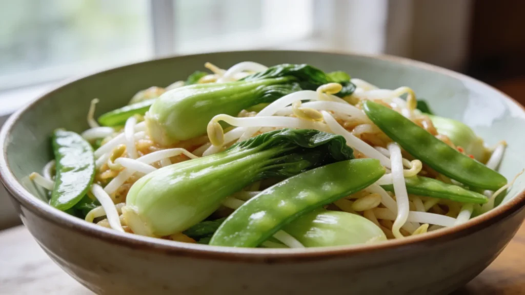 Bowl of veggie chop suey with bean sprouts, bok choy, and snap peas