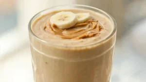 Creamy peanut butter banana smoothie in a glass