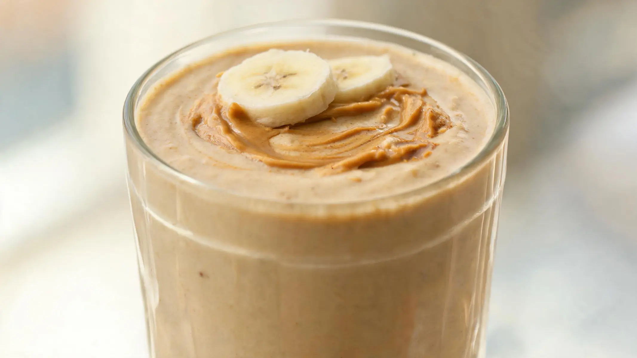 Creamy peanut butter banana smoothie in a glass