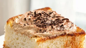 A slice of toasted angel food cake topped with espresso mascarpone cream