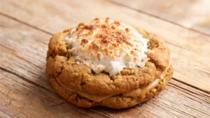 A stack of toasted fluffernutter stuffed cookies with golden brown edges and gooey marshmallow filling